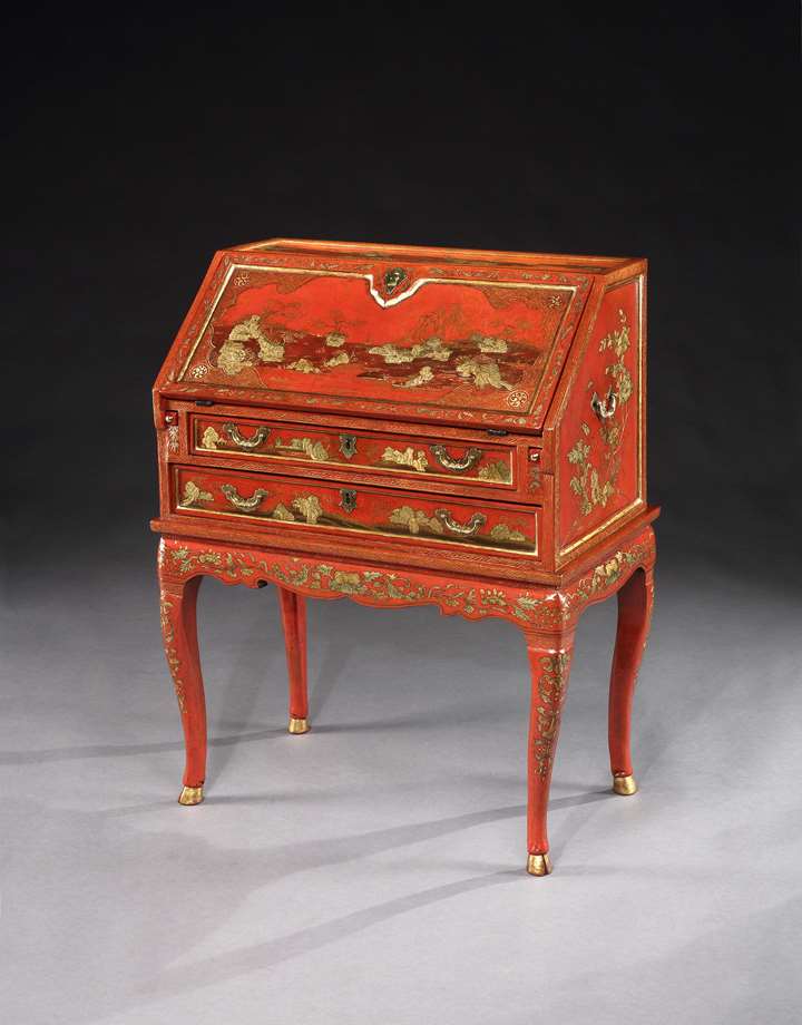 A red lacquer bureau on stand